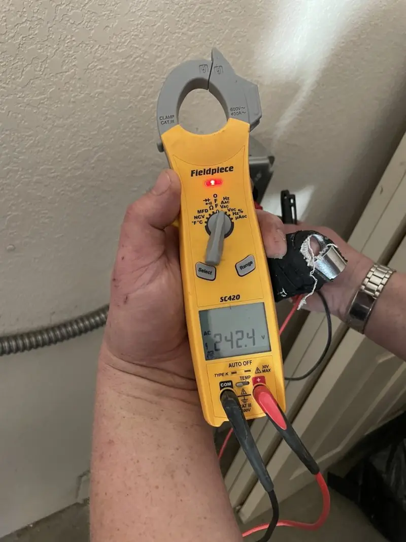 Voltage testing with clamp meter during Ceiling Fan Installation in Huron